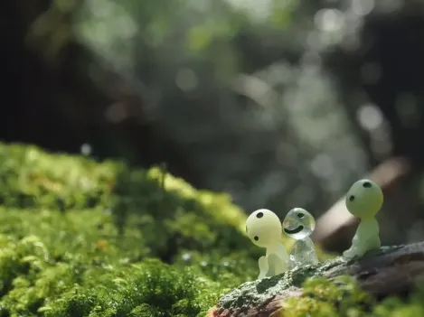 A small spirit figurine placed on green moss