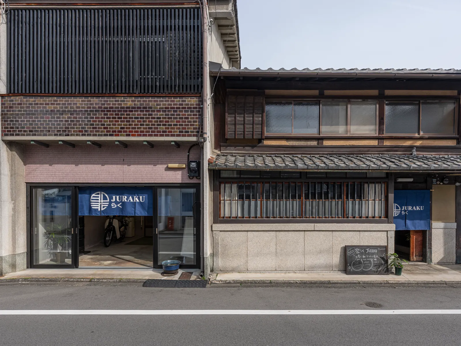 The townhouse exterior with an indigo "JURAKU raku" noren curtain
