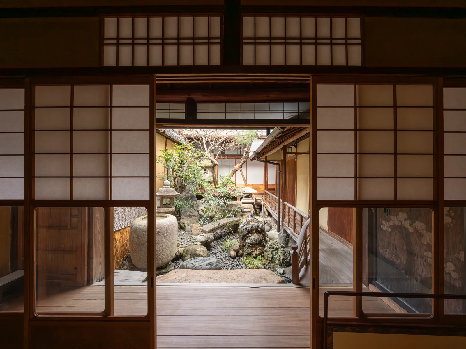 Tsuboniwa garden seen through shoji and lattice doors, with a veranda