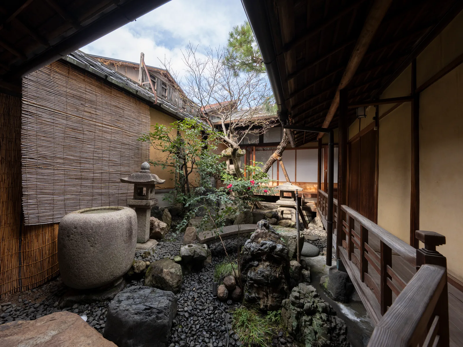 Tsuboniwa garden with a stone lantern, water basin, and stone arrangement