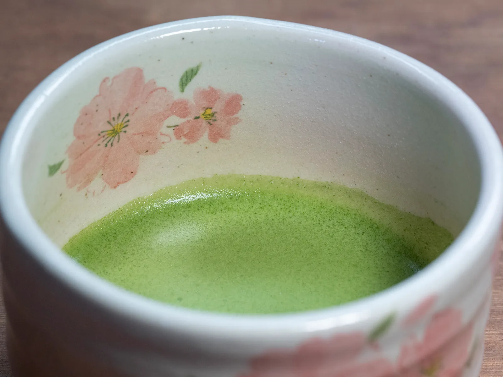 Frothy matcha whisked in a cherry-blossom patterned tea bowl