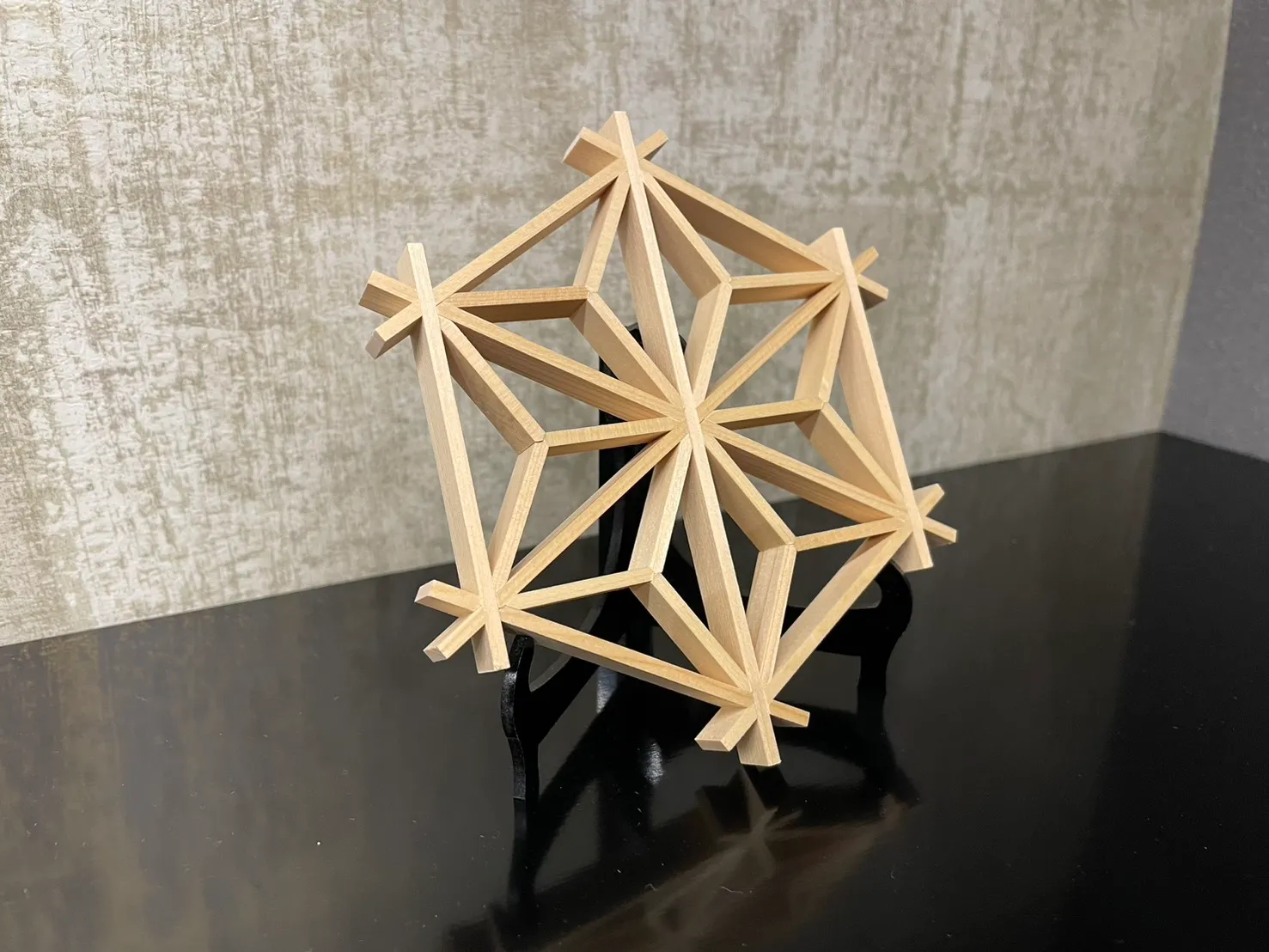 A three-dimensional spherical kumiko piece standing on a stand