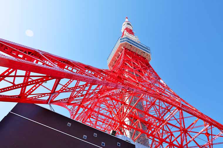 The red Tokyo Tower seen from below under a clear sky